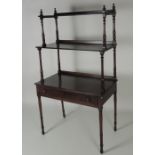 A mahogany three tier rectangular Whatnot, with turned pillar supports,