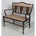 An attractive Edwardian inlaid two seater Settee, with shaped back on square legs,