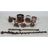 A varied collection of antique copper and brass vessels, funnels, measures etc.