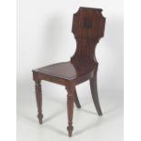 An attractive early 19th Century carved and figured mahogany Hall Chair, with shaped back,