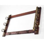 An Edwardian mahogany and brass mounted Gun Rack.