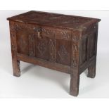 An 18th Century oak Coffer, the top with three carved panels, with original hinges and lock,