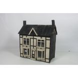 An early 20th Century Tudor type Dolls House, probably Irish, with bay windows,
