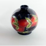 A red, green and blue Moorcraft bulbous Vase, with peaches and blue berries design,