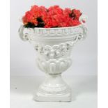 An attractive porcelain two handle Urn, in the classical taste on plinth base.
