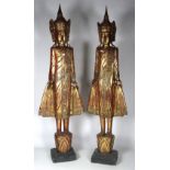 A tall pair of gilded Thai Figures, with inset mirror decoration, each approx. 226cms (89") high.