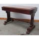 A plain rectangular mahogany Library Table, with turned stretcher and carved paw feet.