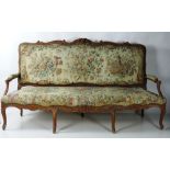 A large 19th Century carved and painted French Settee, the shaped back over outsplayed arms,