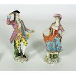 A large pair of early 19th Century Continental porcelain Figures, an elegant Lady and Gentleman,