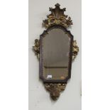 A small 19th Century shield shaped carved giltwood Wall Mirror, with shell decoration.