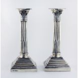 A pair of 20th Century English silver Corinthian Pillar Candlesticks, by Walker & Hall,