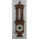 An unusual late Victorian carved oak Barometer / Thermometer,