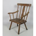 An early 19th Century Irish pine Cottage Armchair, with shape splat back, with out stretched arms,