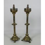 A pair of heavy 19th Century tall brass Candlesticks, with pierced decorated circular tops,