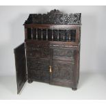An unusual carved and blackened oak Cupboard, in the late 17th Century style,