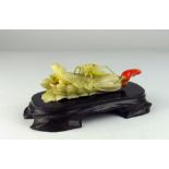 A very fine carved Meiji period Japanese ivory Okimono of a locust perched on a head of celery,