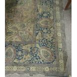 A large cream ground 20th Century silk Carpet, the central panel profusely decorated with flowers,