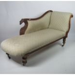 A William IV carved mahogany Chaise-Longue, with a shaped back decorated with carved eagle,