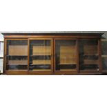 A 19th Century Irish mahogany Apothecary Wall Cabinet, the shaped cornice over four sliding doors,