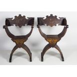 A good pair of 19th Century X shaped Armchairs, with profusely carved back with lion crest,