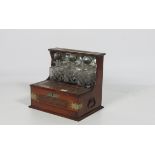 A Victorian oak brass bound and carved Tantalus, with three decanters, and fold out top,