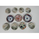 A set of 11 Japanese Plates and Saucers, each decorated with birds in naturalist setting,