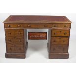 A 19th Century kneehole pedestal Desk, with tooled red leather inset top, with three drawers,