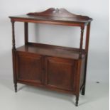 An Irish Edwardian walnut two tier Whatnot, with shaped back,