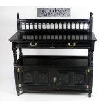 An ebonised carved oak Hall Buffet, with rail back over two frieze drawers,