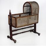 A very good early 19th Century mahogany Child's Cradle, with caned arched hood and sides,