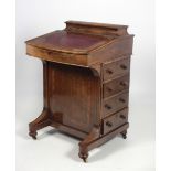 A Victorian walnut Davenport, the lift top with leather inset, and decorated with inlay,
