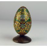 A very attractive gilt ground and colourful Faberge style cloisonné Egg, on a stand,