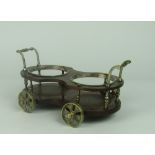 A mahogany and silver plated double Wine Coaster in the shape of a cart,