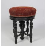 An ebonised circular Piano Stool, with telescopic seat.