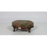 A small Victorian oval walnut Footstool, with carved cabriole legs.
