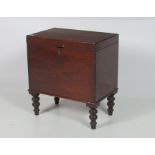A small 19th Century casket shaped mahogany Cellaret, on turned legs.