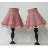 A pair of Spelter Table Lamps, in the shape of Egyptian figures, with original pink shades.