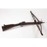 An early 19th Century mahogany and fruitwood Crossbow, with decorated iron mechanism and mounts,