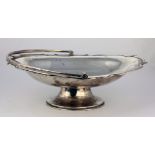 A plain English silver swing handle Basket, with shaped rim, and on an oval foot, Chester c.