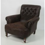 A good pair of hide covered Easy Armchairs, with deep buttoned backs on turned front legs.