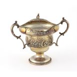 An unusual Birmingham silver three handled Bowl, with floral embossed body c.
