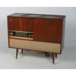 A "Two in One" H.M.V. Record and Radio Player, in a mahogany case on turned feet, approx.