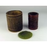 Two carved Chinese bamboo Brush Pots, and a circular jade Medallion carved with dragon.