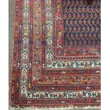 A long 19th Century red ground Hall Carpet, the central panel with navy ground,