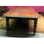 An Irish Victorian mahogany extending Dining Table, with two spare leaves, on shaped bulbous legs,