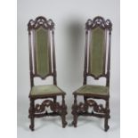 A good pair of carved walnut Cromwellian style high back Hall Chairs,