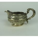 A heavy early William IV Irish silver Cream Jug, with embossed floral body possibly by C.