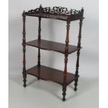 A Victorian walnut three tier Whatnot, with carved and pierced gallery,
