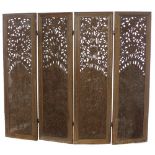 An unusual profusely carved and pierced four fold Indian wooden Screen, decorated with figures,