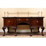 A very fine Chippendale style inverted mahogany kneehole Sideboard, with tall brass gallery rail,